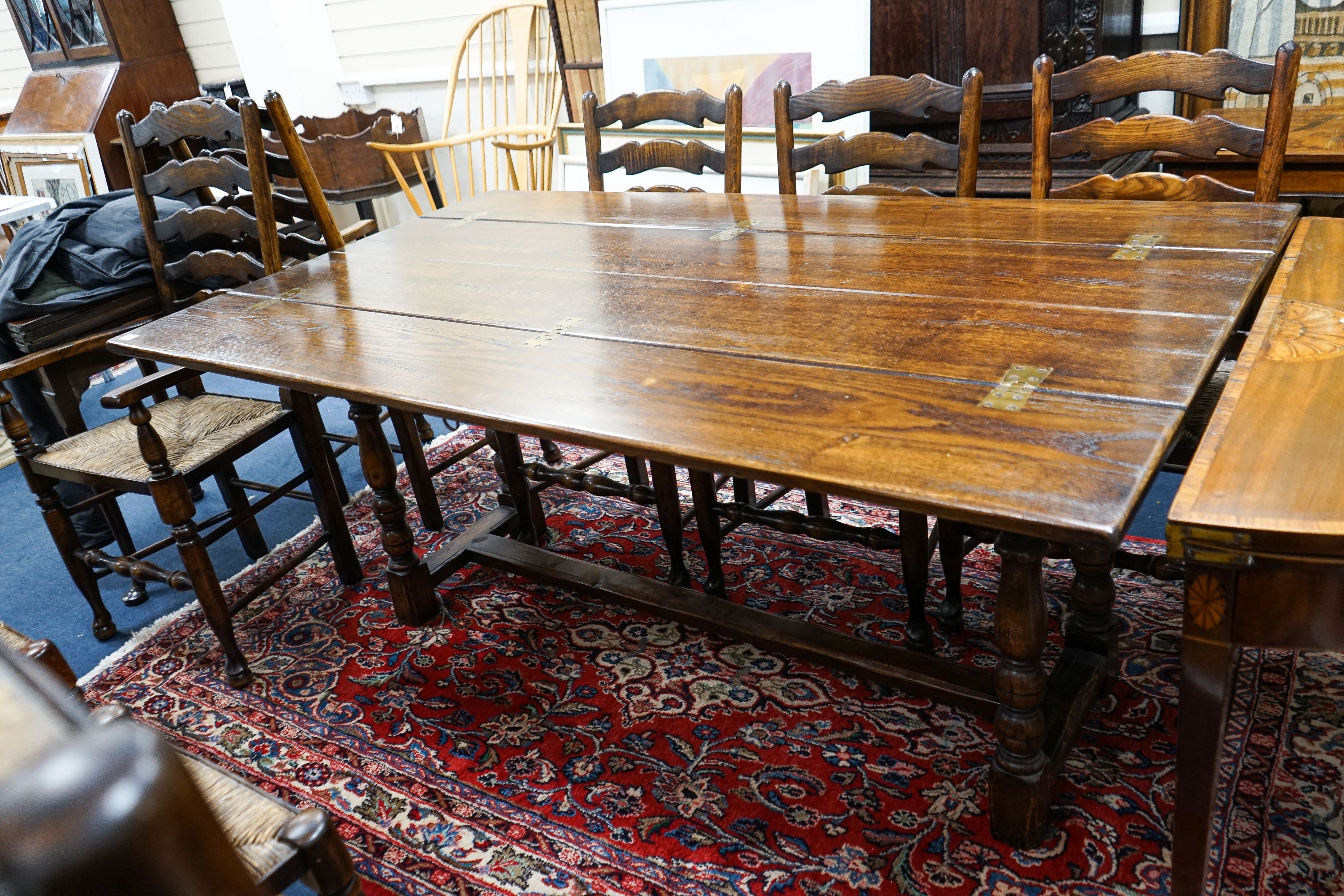 A Titchmarsh & Godwin 18th century style rectangular oak dining table with twin flap folding top, length 170cm extended, depth 99cm, height 74cm